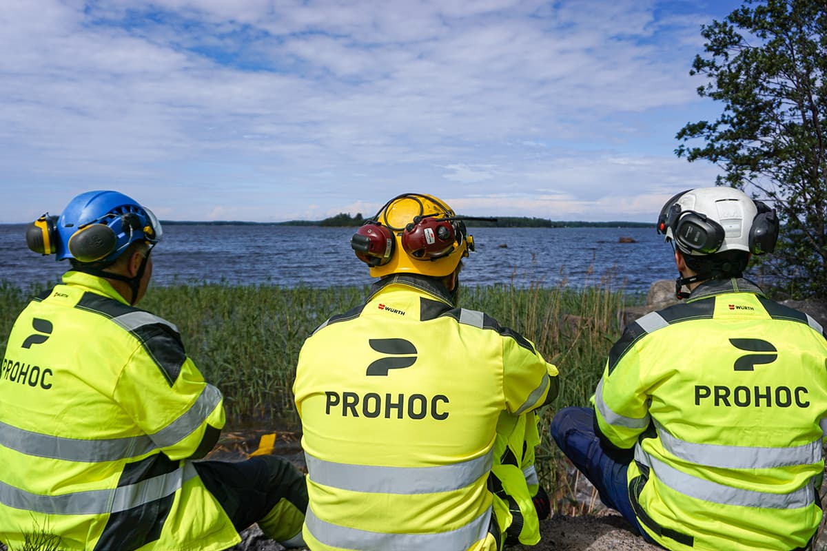 Prohoc workers in yellow work clothes by the sea.